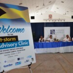 Team members of Alexiou, Knowles & Co. (background) were present at the Post-storm Advisory Clinic to provide legal advice.